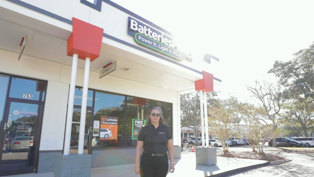 A Batteries Plus franchisee, Ingrid Brummett, standing in front of a storefront.
