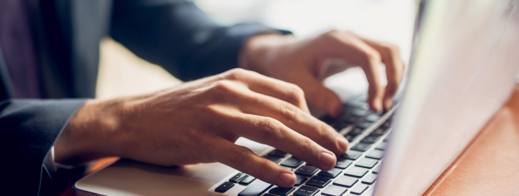 Man typing on a laptop